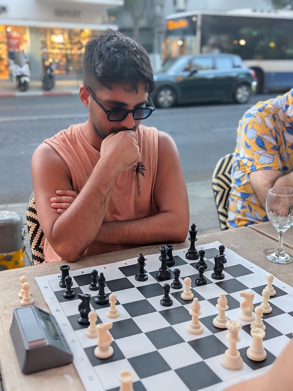 Chess player enjoying wine during a game